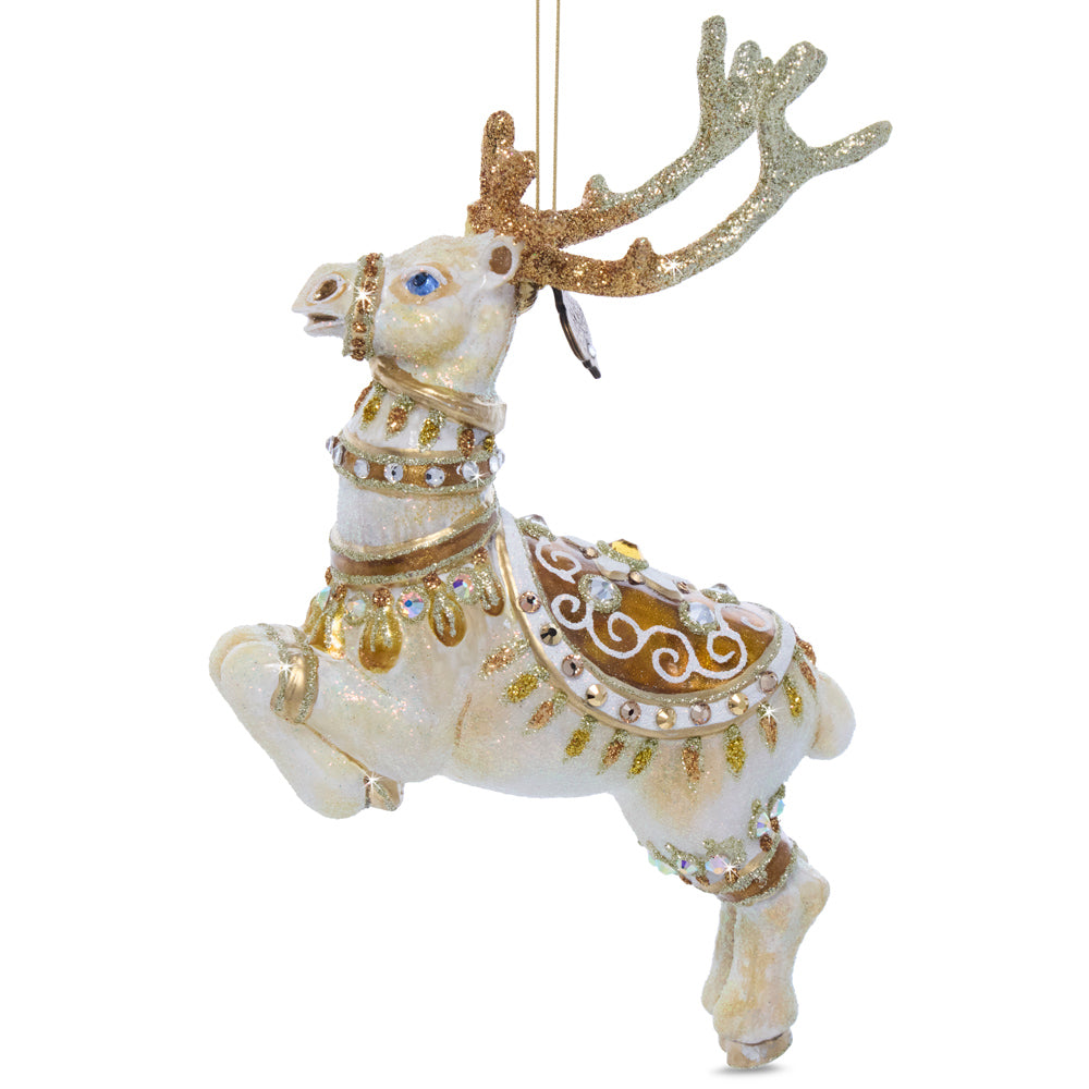 Blitzen Glass Ornament. Santa's reindeer, Blitzen, is hand-painted with white and gold enamel. Adorned with intricate designs, glitter, and crystals. View of back.