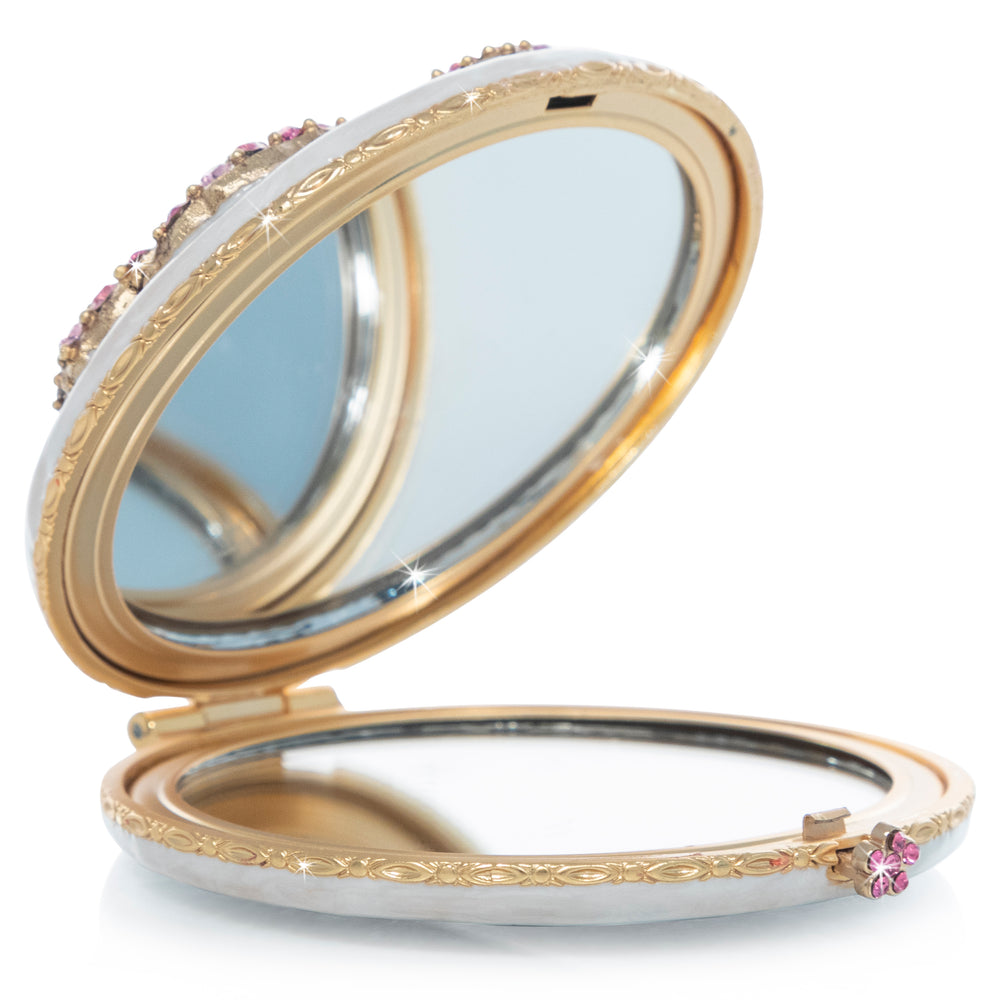 Mae Peony Compact. A pink peony adorned with pink crystals on a white enamel compact. View of left side.