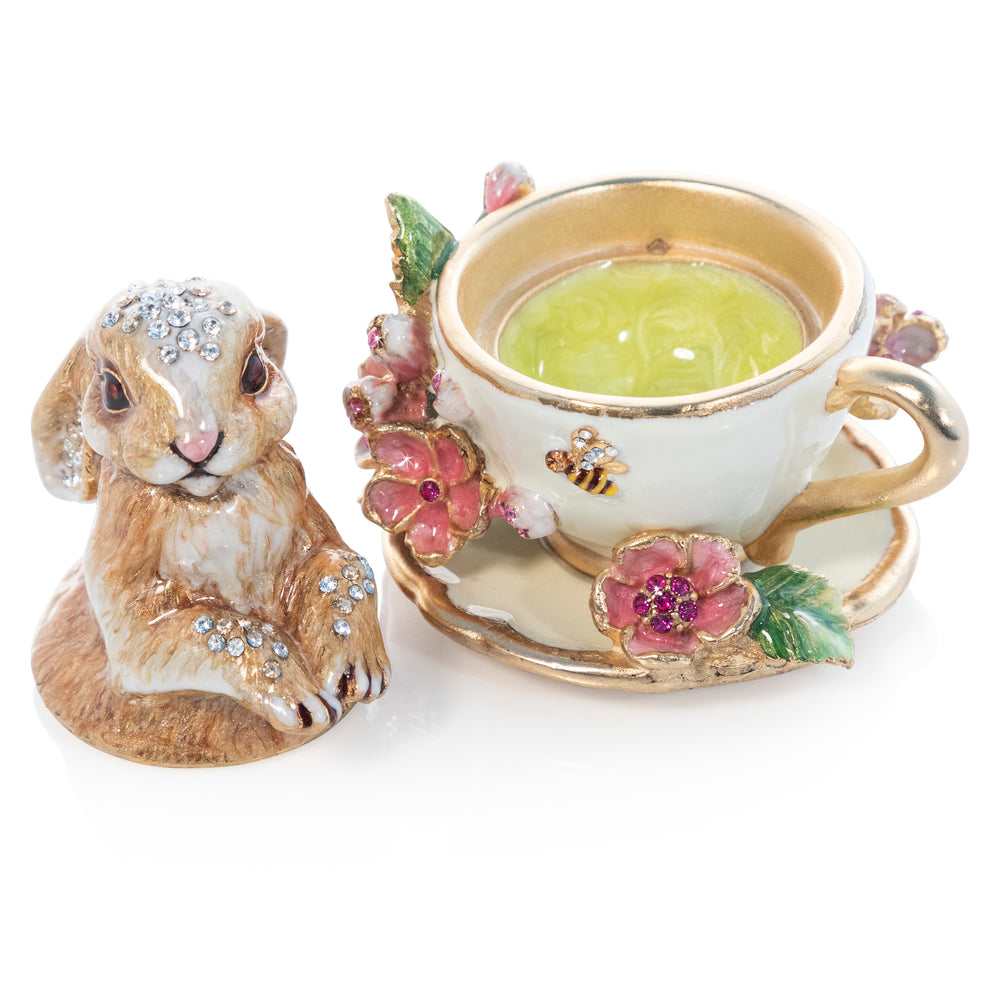 Cerelia Easter Box. A bunny sits in a teacup with flowers and bumble bees. Adorned with crystals. View of lid off, showing light green enamel on inside.